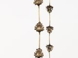 a bunch of flowers hanging from a string on the wall