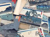 a pile of old japanese paintings on a table