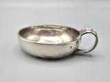 a silver cup that is sitting on a table