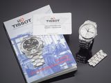 a book and a watch on a table next to a card