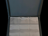 a open suitcase with a lot of white tiles inside of it
