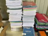 a stack of books sitting on a table next to a cardboard box