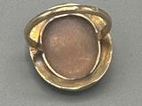 an image of a gold ring with a pink stone in the center