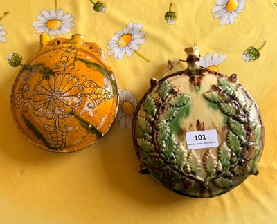 two vases sitting on a yellow tablecloth with daisies