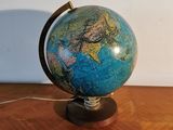 a small blue and green globe on a wooden table