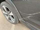 a close up of a car ' s tire on the side of the road