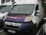 three vans parked in a parking lot next to each other