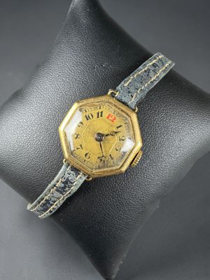 a close up of a wrist watch on a display case