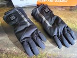 the pair of gloves are sitting on the table next to the box