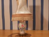 a lamp that is sitting on a table with a lamp shade on it