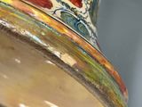 a vase that has a colorful design on it