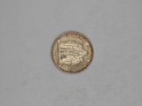 a small coin with a picture of a woman on it