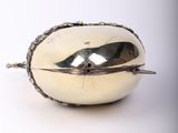 a silver object that is sitting on a white surface