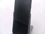 a cell phone that is sitting on top of a stand