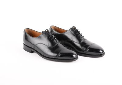 a picture of a pair of black shoes on a white background