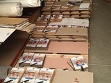 many boxes of mail sitting on the floor in a warehouse