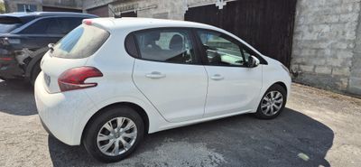 a small white car that is parked in a parking lot