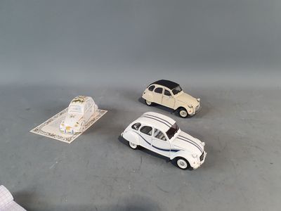 three toy cars sitting next to each other on a table