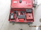 a red tool box with tools in it on the floor
