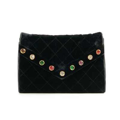 a black clutch bag with multi colored stones on it