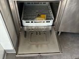 a dishwasher with a basket inside of it in a kitchen
