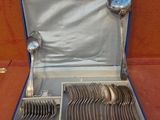 silverware in a blue case on a table with a red background
