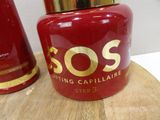 a red jar with a gold lid sitting on a wooden table