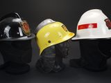 three different types of hard hats are lined up against a black background