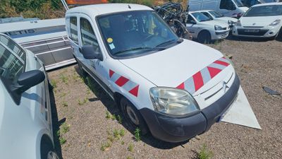 a white van with red and white stripes parked in a parking lot