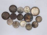 a close up of a pile of old coins on a white surface