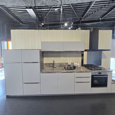 a kitchen with a stove, sink, oven and refrigerator