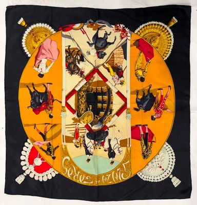 a black and yellow scarf with a picture of a man on a horse