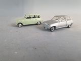 two toy cars that are sitting next to each other