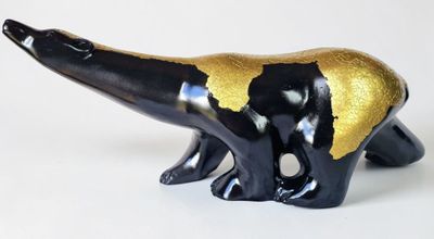 black and gold polar bear figurine on a white background