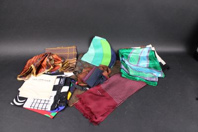 many different types of ties laid out on a black surface