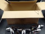 a box with a bunch of chrome handles on a table