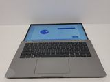 a laptop computer sitting on a table with a blue screen