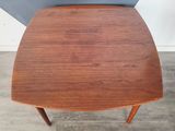 a close up of a table with a wooden top on a wooden floor
