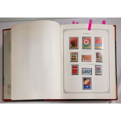 an open book with stamps on it on a table