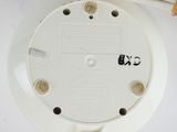 a close up of a white smoke detector on a table