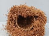 a bird nest made out of straw on a white surface