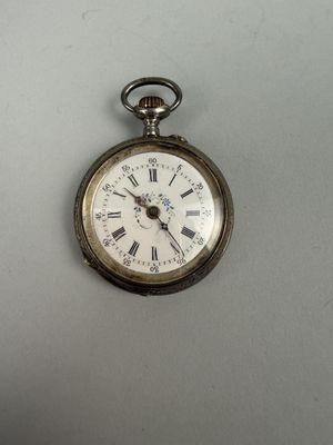 a silver pocket watch with roman numerals on it