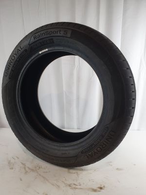 a close up of a tire on a white surface with a white curtain in the background