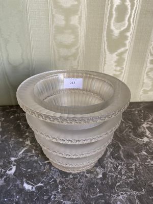 a white vase with a tag on it sitting on a table