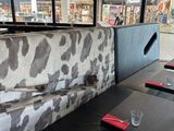 a cow print couch in the corner of a restaurant