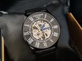 a black watch in a box with a black leather case