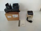 two cell phones sitting on a table next to a box
