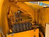a close up of a yellow machine with a bunch of wires attached to it