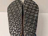 the soles of a pair of black shoes are on top of a blue box
