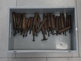 a lot of baseball bats in a box on the floor